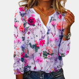 Purple floral V-neck blouse made of lightweight chiffon fabric with long sleeves, displayed on a mannequin against a white background.