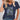 Floral V-Neck Women's T-Shirt in dark green, featuring eco-friendly fabric, displayed on a mannequin, highlighting the neckline and shoulder area with a plant in the background.