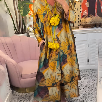 Yellow floral V-neck summer dress for women in mustard yellow color, featuring a casual and fashionable design, displayed on a mannequin with a hat and sunglasses, emphasizing the short sleeves and fitted waist.