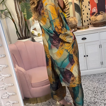 A woman wearing a floral V-neck yellow summer dress, featuring a casual fashion style. The dress has short sleeves and a fitted waist, paired with fashionable eyewear. The dress length reaches the knee, showcasing a stylish and comfortable look suitable for warm weather.