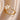 Elegant gold floral engagement ring featuring a flower-shaped diamond design with intricate petal details.