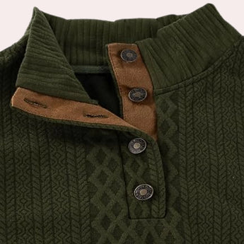 Forest green men's wool cable knit sweater with elbow patches, featuring a textured design and a collar, displayed on a hanger.