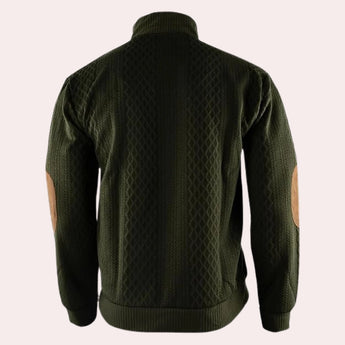 Men's forest green wool cable knit sweater with elbow patches, featuring a high neckline and long sleeves.