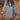 Forest green oversized cable knit sweater dress with a cozy turtleneck, featuring a relaxed fit and long sleeves, worn by a person with shoulder-length hair and sunglasses.