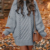 Forest green oversized cable knit sweater dress featuring a cozy turtleneck design. The dress has long sleeves and an ample fit, extending to the knees, highlighting a casual and comfortable style.