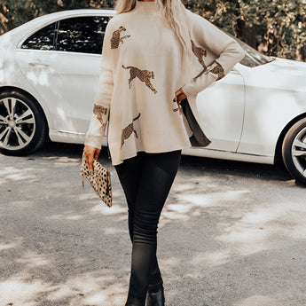 A beige XL fuchsia ethnic pattern sweater featuring boho chic embroidery, displayed with emphasis on its intricate design.