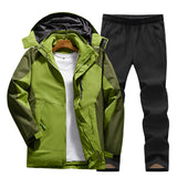 Men's green hooded track jacket with black moisture-wicking pants, featuring long sleeves and a collar, suitable for sportswear or workwear.