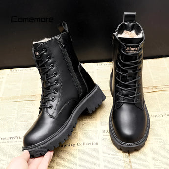 Black women's winter combat boots with fur lining, featuring insulated material and high-traction soles, displayed against a plain background.