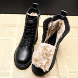 Black women's winter combat boots featuring a fur lining, insulated for warmth and designed with high-traction soles.