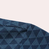 Men's polo shirt featuring a geometric blue triangle pattern with a tartan and plaid design, showcasing shades of azure and electric blue. The shirt has short sleeves and a casual yet stylish appearance, ideal for a modern and fashionable look.