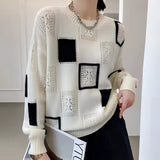 Women's fashion sweater with a geometric checkerboard pattern, featuring a crewneck style and long sleeves. The sweater is primarily white and designed as a one-piece outerwear garment, highlighting modern and stylish fashion elements.