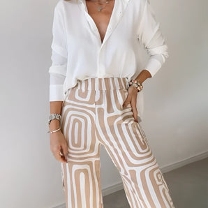 
A pair of women's geometric high waist beige trousers displayed in a fashion-forward setting, showcasing the elegant design and tailored fit around the waist and thighs.