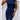 Woman wearing a fitted geometric print dress in white and black with chain design, short sleeves, and knee-length, variant in marine blue, size 2XL.