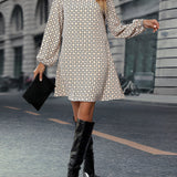 Woman wearing a geometric print long sleeve mini dress with a casual chic fall fashion vibe, showing shoulder and knee-length features.