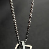 Geometric silver square frame pendant necklace, modern minimalist design, made of silver metal, fashion accessory, body jewelry.