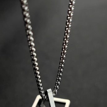 Geometric silver square frame pendant necklace, modern minimalist design, made of silver metal, fashion accessory, body jewelry.
