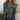 Silver glitter V-neck top with sequin long sleeves, shown in Nero color, size 2XL, displayed on a mannequin highlighting the fashion-forward shoulder and waist design.