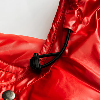 Glossy black insulated hooded puffer jacket with shiny finish, featuring a sleek design with attention to collar and sleeve details, showcasing luxury outerwear fashion.