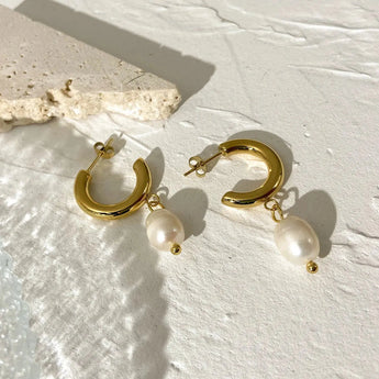 Gold Crescent Pearl Drop Earrings with a modern luxury design, featuring a gold crescent shape adorned with elegant pearl drops.