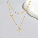 Gold cross pendant necklace with a minimalist layered design, featuring an adjustable gold-color chain measuring 38-43 cm.