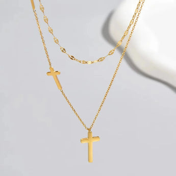 Gold cross pendant necklace with a minimalist layered design, featuring an adjustable gold-color chain measuring 38-43 cm.