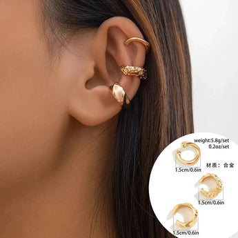 Gold diamond-studded hoop earrings with a textured polished finish worn by a woman.