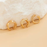 Gold diamond-studded hoop earrings for women, featuring a luxurious design with circular metal hoops and embedded diamonds, perfect as a high-end fashion accessory.