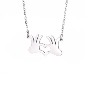 Gold hand heart necklace featuring a romantic love gesture pendant, designed for couples, with a delicate chain and elegant metal finish.