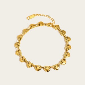 Gold heart chain bracelet in gold tone, featuring customizable and tarnish-free design, made by YA-CHAN Jewelry, displayed on a white background showcasing its elegant and artistic oval and circle links.