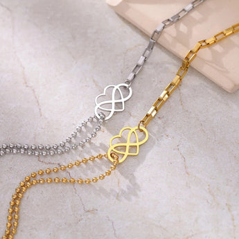 Gold heart charm bracelet with adjustable chain, featuring a dainty design, made of metal, and suitable as an elegant jewelry gift.