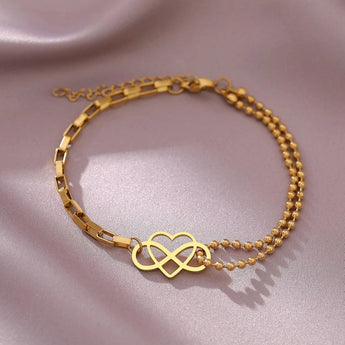 Gold heart charm bracelet with adjustable chain, featuring a dainty and elegant design, perfect as a jewelry gift.