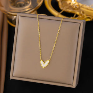 Gold heart pendant necklace with minimalist design, featuring a white background.