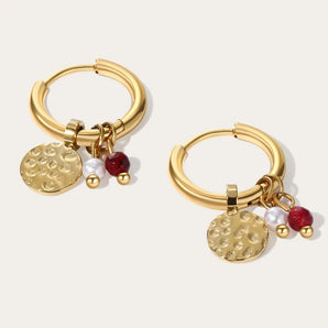 Gold hoop earrings with dangle pearl and textured disc charms in a gold-tone finish.