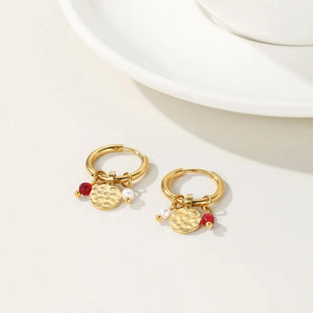 Gold hoop earrings with dangle pearl and textured disc charms, designed by YA-CHAN, showcasing a combination of natural materials and intricate metalwork.