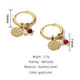 Gold hoop earrings with designer dangle pearl and textured disc charms, featuring circular gold metal with pearl accents.