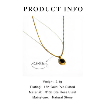 Gold locket necklace with black onyx and white stone, showcasing two-tone design on a white background.