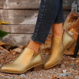 Gold metallic pointed toe ankle boots with a zipper, featuring a low heel design. The boots are showcased on a model's legs, highlighting their fashionable appearance suitable for both casual and dressy occasions.
