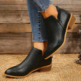 Gold metallic pointed toe ankle boots with a low heel and a zipper, shown in black size 42, worn on a human leg against a neutral background.