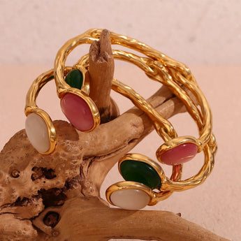 Gold Pink Cabochon Bracelet - Luxury designer jewelry for women featuring a metal bangle with pink cabochon stones, a fashionable and elegant accessory.
