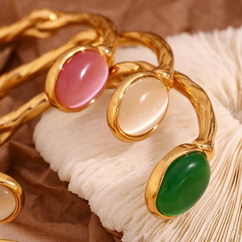 Gold pink cabochon bracelet featuring elegant gemstones and pearls, luxury designer jewelry for women.