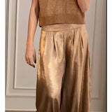 Gold pleated metallic trousers in a luxury chic design, featuring a high-waisted fit, tailored for plus-size (3XL), with a glamorous, shimmering golden hue ideal for party wear. The trousers showcase a stylish and modern fashion design suitable for elegant occasions.