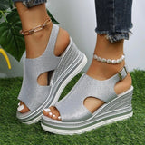 Gold sparkle peep toe wedge sandals with a platform espadrille design, in silver, displayed on a model's foot against a neutral background.