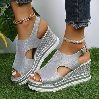 Gold sparkle peep toe wedge sandals with a platform espadrille design, in silver, displayed on a model's foot against a neutral background.
