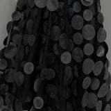 Gothic black high-waist layered circle skirt in alternative fashion style, showcasing flowing textile layers with black and white contrast.