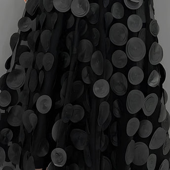 Gothic black high-waist layered circle skirt in alternative fashion style, showcasing flowing textile layers with black and white contrast.