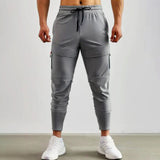 Gray men's tapered joggers, lightweight athletic sweatpants showing the waist, thigh, knee, and leg areas.