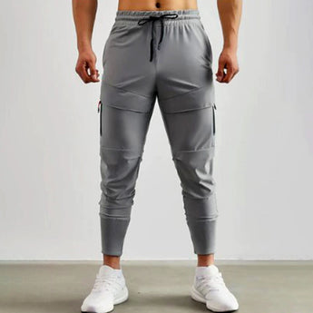 Gray men's tapered joggers, lightweight athletic sweatpants showing the waist, thigh, knee, and leg areas.
