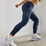 Men's gray tapered joggers displayed, showcasing a lightweight athletic design with a focus on comfort and style. The sweatpants feature a fitted waist and tapered legs, ideal for sportswear or casual fashion.