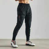 A pair of black, lightweight athletic tapered joggers in size 2XL displayed against a neutral background, highlighting the waist, knee, and thigh areas.
