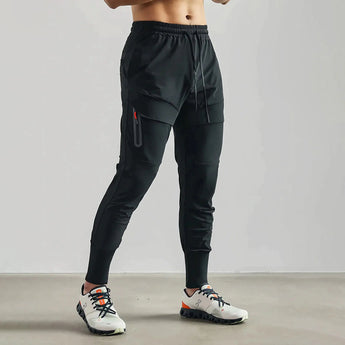 A pair of black, lightweight athletic tapered joggers in size 2XL displayed against a neutral background, highlighting the waist, knee, and thigh areas.